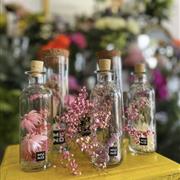 Dried flowers in a glass bottle
